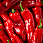 Fresh red romano peppers background