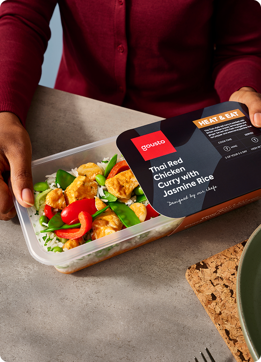 Person opening a Gousto heat-and-eat Thai curry ready meal ready for dinner