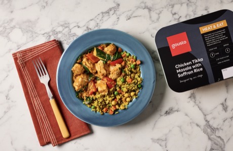 Chicken tikka masala with saffron rice in a Gousto heat-and-eat tray, served on a blue plate