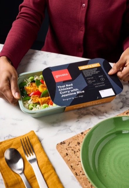 Person opening a Gousto heat-and-eat Thai curry ready meal ready for dinner