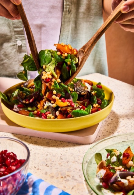 Serving bowl of a freshly made salad being dished up for dinner