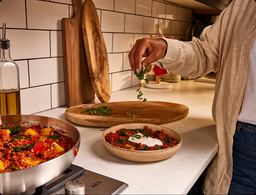 Customer serving a delicious Sweet Potato And Black Bean tomato Stew