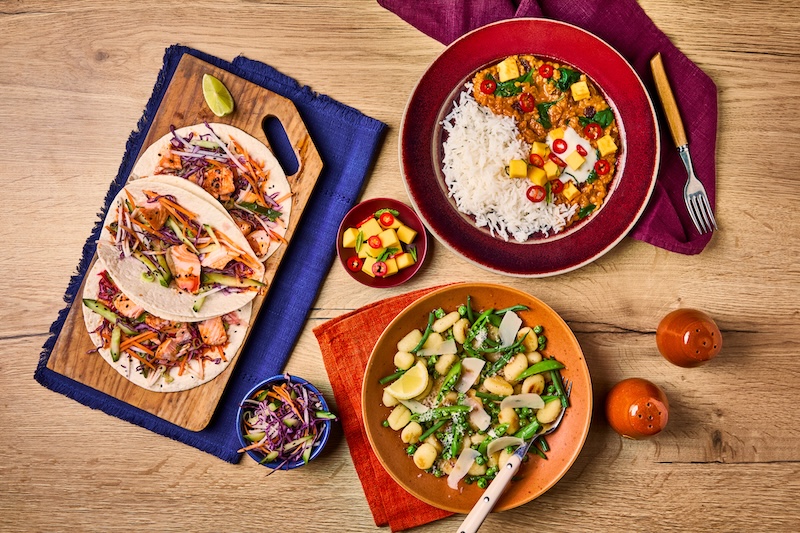 Table served with Salmon Tacos and fresh coleslaw salad, Mango and coconut dhal With Fluffy Rice and Spring vegetables gnocchi in a creamy lemon and cheese sauce