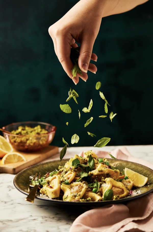 A bowl of veggie tortiglioni with pesto and fresh basil, part of Gousto's 10 minute meals