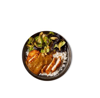 A crispy breaded katsu served on a bed of white rice and drizzled with curry sauce