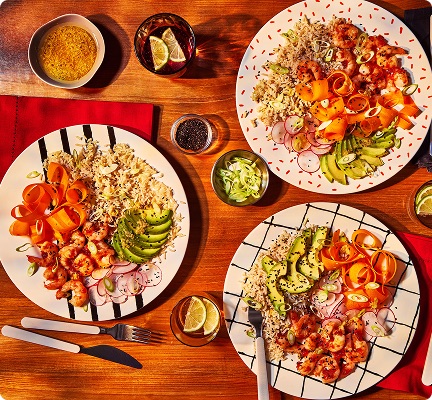 Step 1: Three-person dinner table with a healthy Gousto recipe, cooked at home.