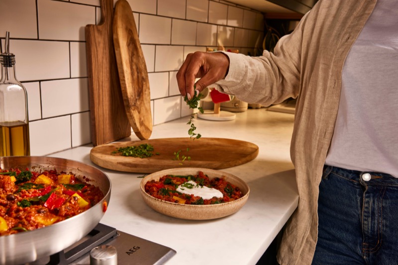 Customer finishing up a creamy Sweet Potato And Black Bean tomato Stew