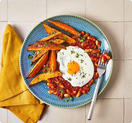 Cater to dietary preferences: An Indian-Style Beans With Fried Egg And Sweet Potato Wedges recipe which suits dietary needs.
